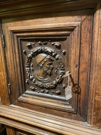 A walnut 'credence' case with portrait medallions, probably France, late 17th C. with later elements