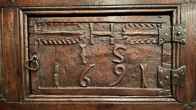 A Flemish carved oak two-door and two-drawer buffet with the Passion Instruments, dated 1691