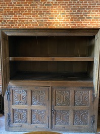 A rare large Flemish oak four-door cupboard with carved X-panels and wrought iron mounts, 1st half 16th C.