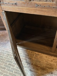 A rare large Flemish oak four-door cupboard with carved X-panels and wrought iron mounts, 1st half 16th C.