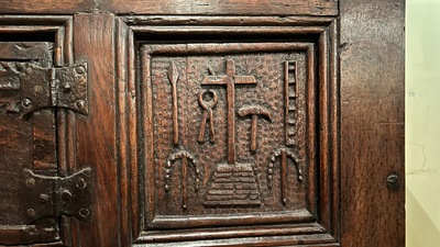 A Flemish carved oak two-door and two-drawer buffet with the Passion Instruments, dated 1691