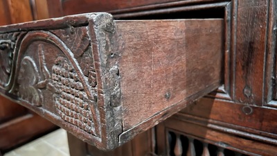 A Flemish carved oak two-door and two-drawer buffet with the Passion Instruments, dated 1691