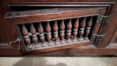 A Flemish carved oak two-door and two-drawer buffet with the Passion Instruments, dated 1691