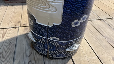 A large blue and white Arita porcelain cylindrical vase or umbrella stand with molded design, Japan, Meiji, 19th C.
