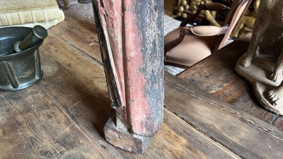 A Flemish carved and polychromed oak figure of a bishop on an armorial base, ca. 1500