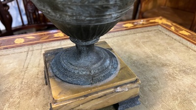 A pair of neoclassical style vases with charioteers on a Siena marble base, 19/20th C.