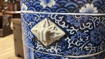 A large blue and white Arita porcelain cylindrical vase or umbrella stand with molded design, Japan, Meiji, 19th C.