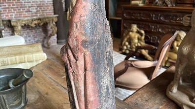 A Flemish carved and polychromed oak figure of a bishop on an armorial base, ca. 1500