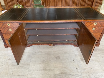 An English neoclassical leather-topped mahogany library desk with gilt bronze mounts, 19th C.