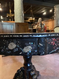 A black lacquered table with polychrome chinoiserie design and mother-of-pearl inlay, ca. 1900