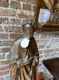 A Flemish carved oak figure of Saint John the evangelist, 1st half 16th C.
