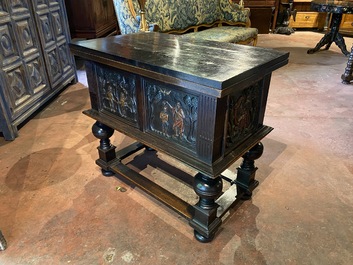 A rare ebonised wooden baluster leg table with polychromed reliefs, 17th C. with later elements