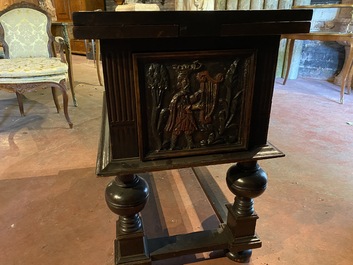 A rare ebonised wooden baluster leg table with polychromed reliefs, 17th C. with later elements