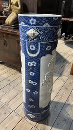 A large blue and white Arita porcelain cylindrical vase or umbrella stand with molded design, Japan, Meiji, 19th C.