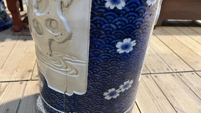 A large blue and white Arita porcelain cylindrical vase or umbrella stand with molded design, Japan, Meiji, 19th C.