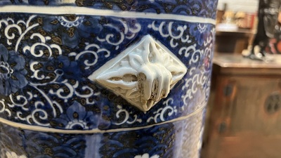 A large blue and white Arita porcelain cylindrical vase or umbrella stand with molded design, Japan, Meiji, 19th C.