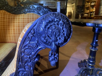 An Anglo-Indian colonial carved wooden sofa with two matching chairs, late 19th C.