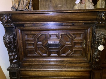 A Flemish ebonised and oak wooden four-door cabinet, 17th C.