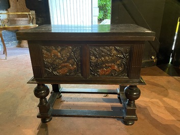 A rare ebonised wooden baluster leg table with polychromed reliefs, 17th C. with later elements