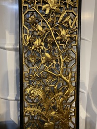 A pair of Chinese openworked and gilt wooden panels with floral design, 19/20th C