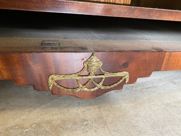 An English neoclassical leather-topped mahogany library desk with gilt bronze mounts, 19th C.