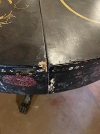 A black lacquered table with polychrome chinoiserie design and mother-of-pearl inlay, ca. 1900