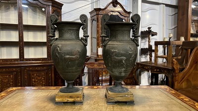 A pair of neoclassical style vases with charioteers on a Siena marble base, 19/20th C.