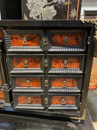 An ebonised wooden cabinet with faux-tortoiseshell veneer, 19th C.