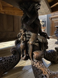 An Anglo-Indian colonial table on a well-carved stand with lions and peacocks, 19th C.