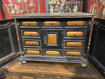 An ebonised and inlaid wooden cabinet, 19th C.