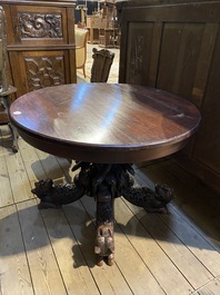 An Anglo-Indian colonial table on a well-carved stand with lions and peacocks, 19th C.