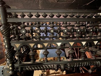 An attractive ebony-inlaid ebonised wooden cradle, 19th C.