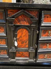 An ebonised wooden cabinet with faux-tortoiseshell veneer, 19th C.