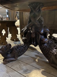 An Anglo-Indian colonial table on a well-carved stand with lions and peacocks, 19th C.