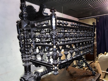 An attractive ebony-inlaid ebonised wooden cradle, 19th C.