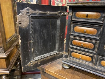 An ebonised and inlaid wooden cabinet, 19th C.