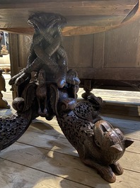 An Anglo-Indian colonial table on a well-carved stand with lions and peacocks, 19th C.