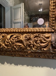 A finely carved gilt wooden mirror, probably Italy, 17/18th C.