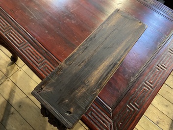 A finely carved Japanese red patinated wooden desk with armchair, 20th C.