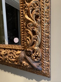 A finely carved gilt wooden mirror, probably Italy, 17/18th C.