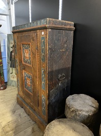 A German polychrome pine single-door cupboard, 18/19th C.