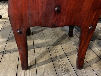 A finely carved Japanese red patinated wooden desk with armchair, 20th C.