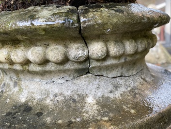 A pair of stone garden vases on square bases, one dated 1873