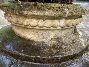 A pair of stone garden vases on square bases, one dated 1873