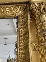 An impressive French Empire-style gilt wooden mirror on faux marble-painted stand, 19th C