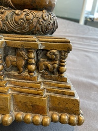 A large Tibetan brass and copper Buddha on throne, probably 16th C.