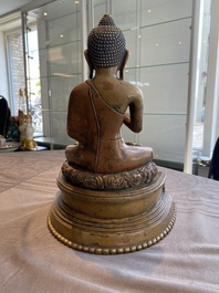 A large Tibetan brass and copper Buddha on throne, probably 16th C.