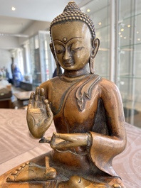 A large Tibetan brass and copper Buddha on throne, probably 16th C.