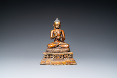 A large Tibetan brass and copper Buddha on throne, probably 16th C.