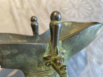 A Chinese bronze ritual wine vessel or 'jue', inscribed and dated 1701, Kangxi